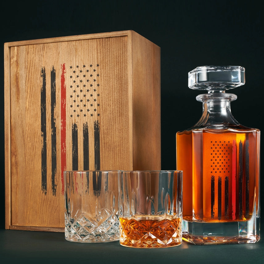 Firefighter whiskey decanter set with red American flag design including decanter and two glasses.