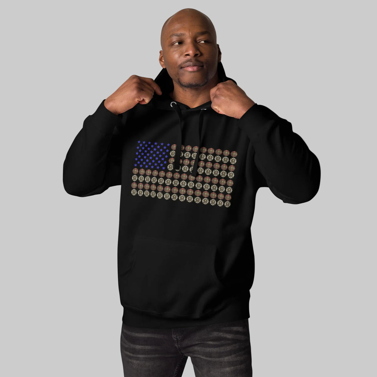 Firefighter wearing black premium hoodie with Maltese cross USA flag design by The Salty Medic