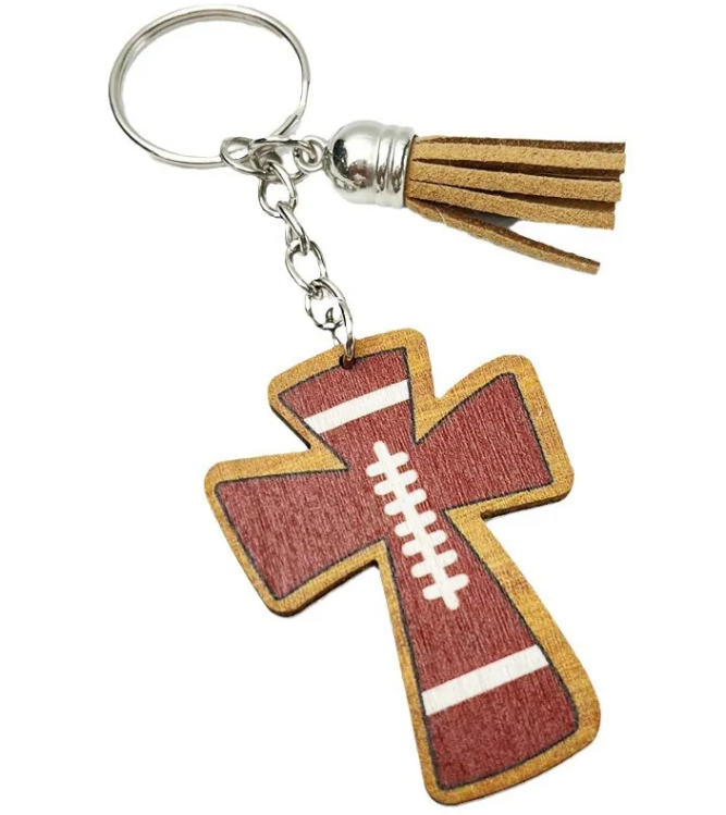 Brown wooden cross keychain with white football laces and brown tassel