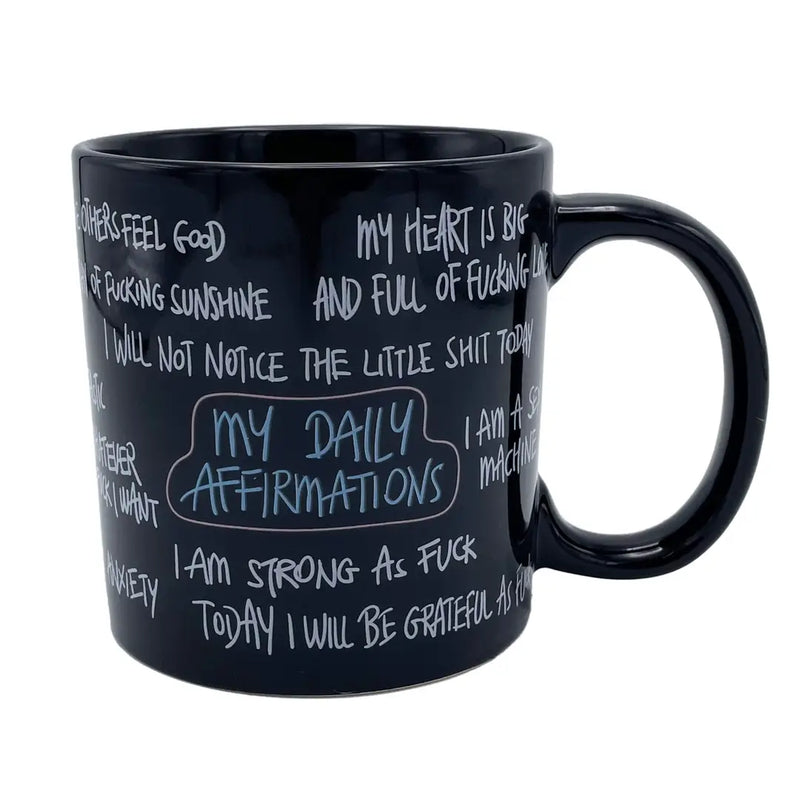 Angled view of the giant 22 oz funny daily affirmation coffee mug featuring adult humor and sarcastic motivational quotes on a black ceramic coffee cup.