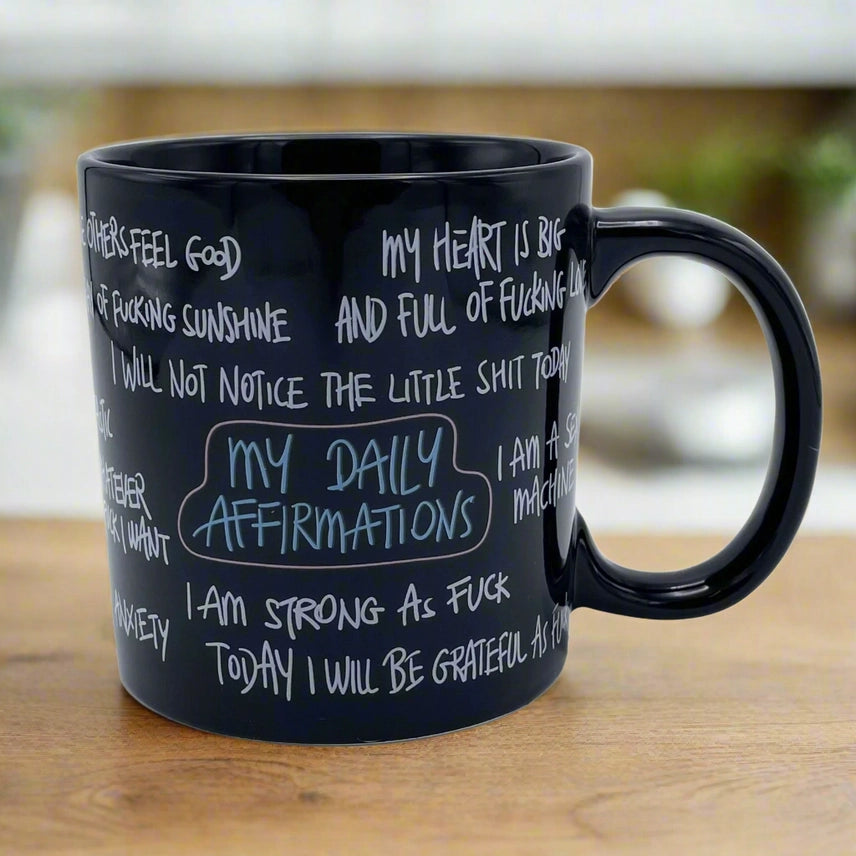 Giant 22 oz funny daily affirmation coffee mug with humorous adult quotes printed on a black ceramic mug, perfect as a sarcastic gift for coworkers, nurses, EMS, teachers, and coffee lovers.