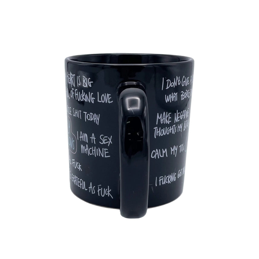 Rear angled view of the oversized black ceramic funny affirmation coffee mug featuring humorous adult quotes and large 22 oz capacity.