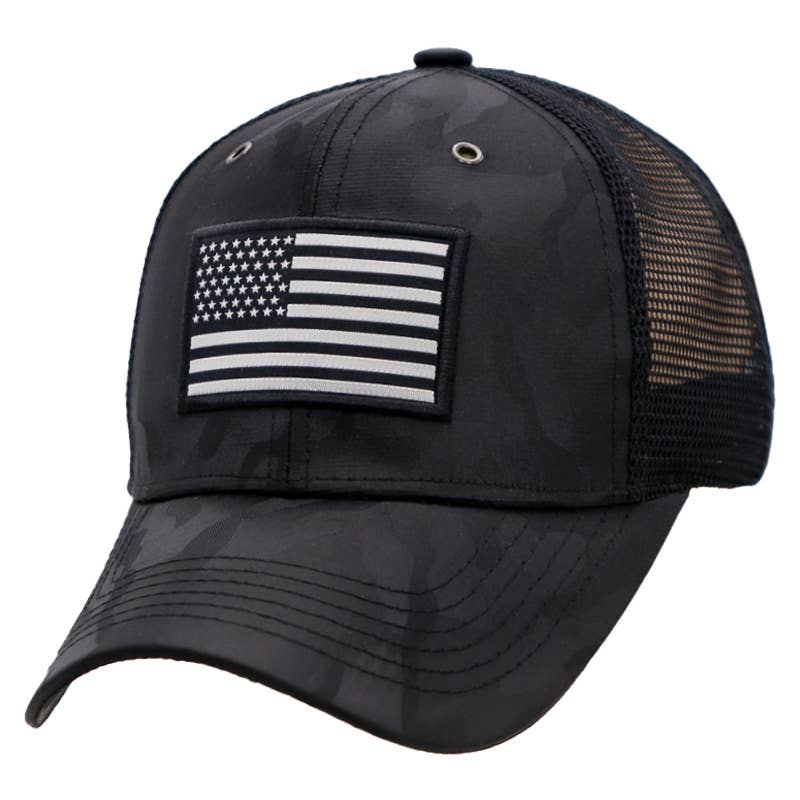 Black camouflage trucker hat featuring a monochrome American flag patch and breathable mesh back