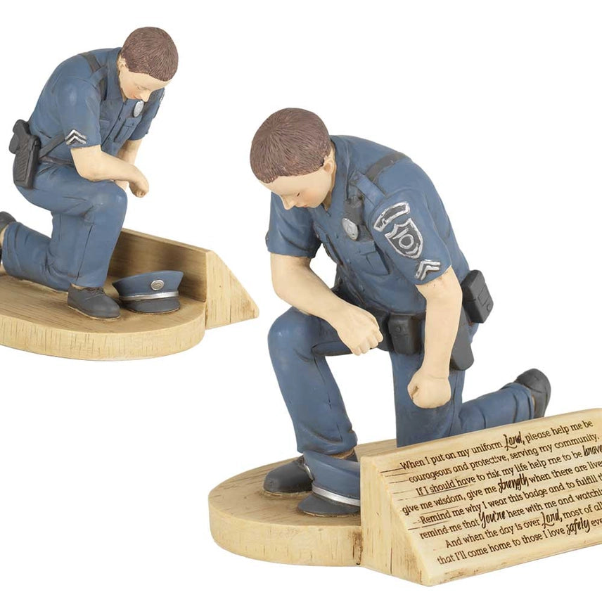 Police officer’s prayer figurine showing a kneeling officer in prayer.