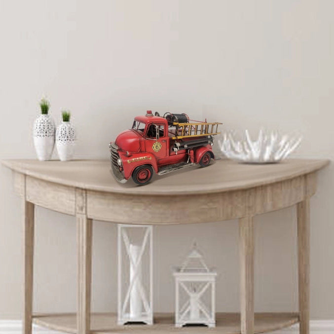 Handcrafted vintage fire truck metal model with rustic firefighter desk and office decor design.