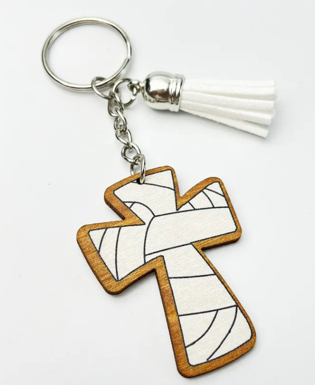White wooden cross keychain with black volleyball lines and white tassel